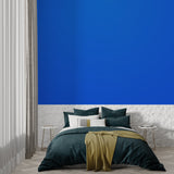 Blue statement wall mural in a contemporary office space with glass desk