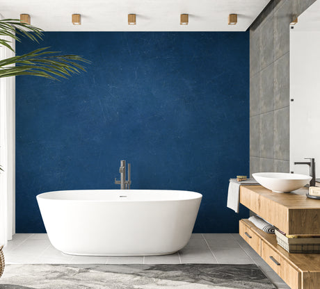 Navy blue textured wallpaper in modern living room with grey sofa and natural light