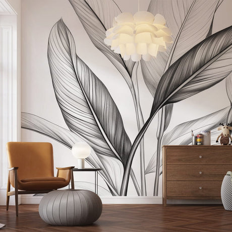 Black and white botanical leaf mural wallpaper in a modern living room, creating a dramatic feature wall