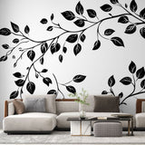 Black and white botanical wallpaper creating a striking feature wall in a modern living room with minimal furniture