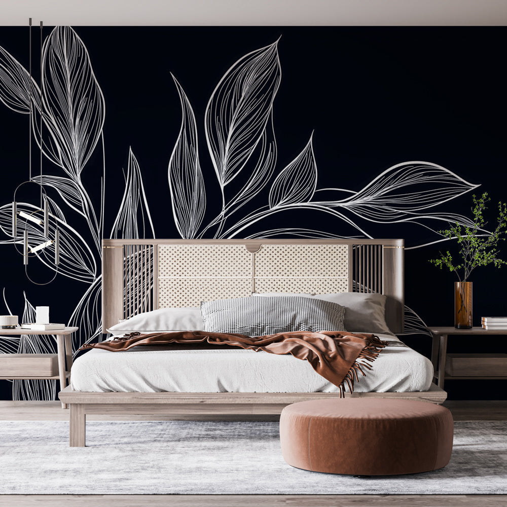 Black and white botanical leaf wallpaper creating a stunning focal point in a modern dining room with natural light