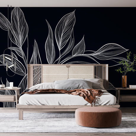 Black and white botanical leaf wallpaper creating a stunning focal point in a modern dining room with natural light