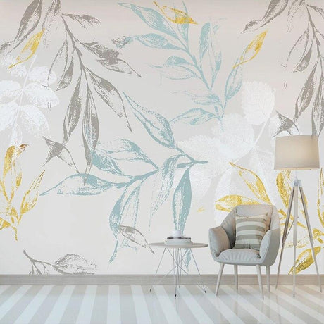 Botanical leaf wallpaper with blue and gold tones creating a calm atmosphere in a modern living room