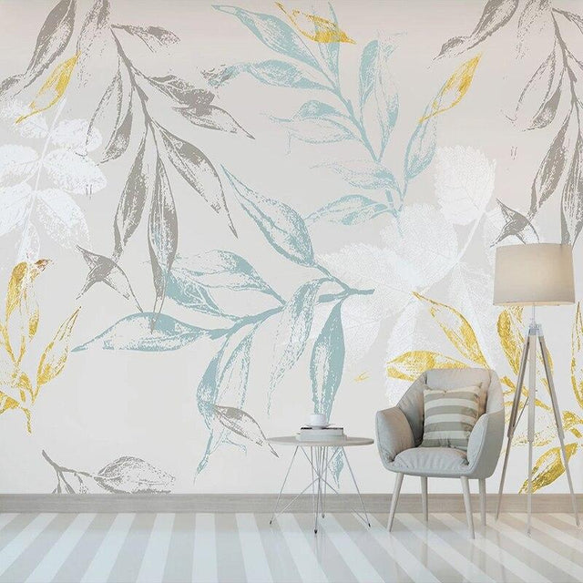Botanical leaf wallpaper with blue and gold tones creating a calm atmosphere in a modern living room