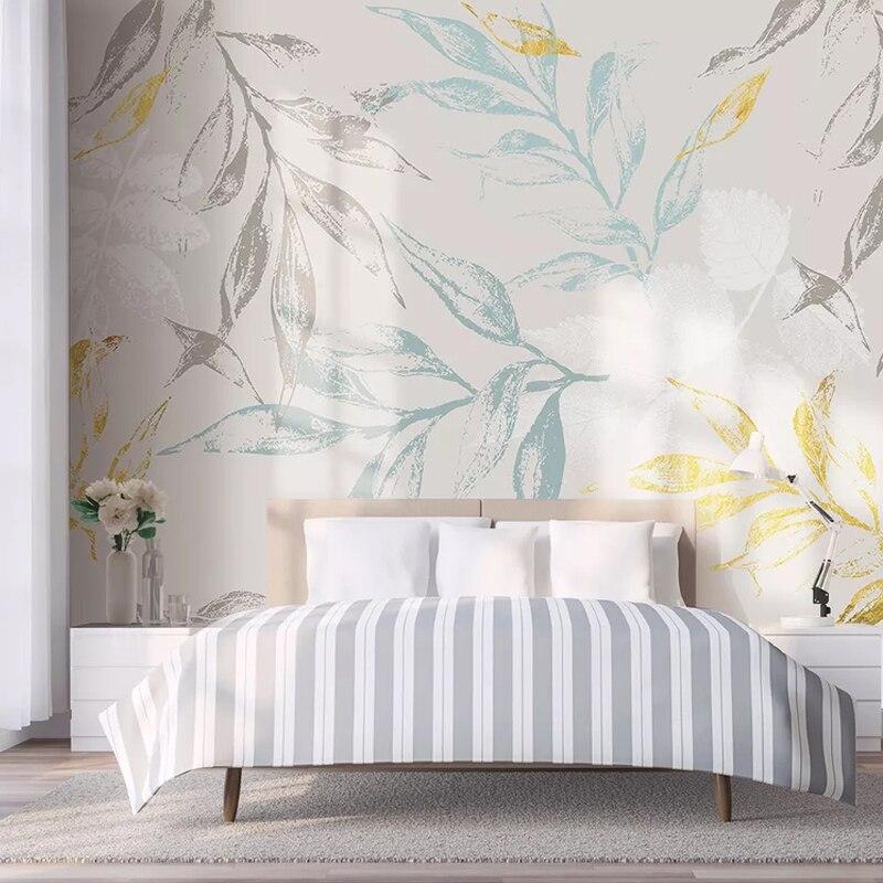 Elegant botanical wallpaper featuring blue-grey leaves in a bright home office setting