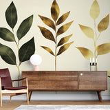 Botanical leaf wallpaper with gold accents creating an elegant atmosphere in a modern living room with natural light