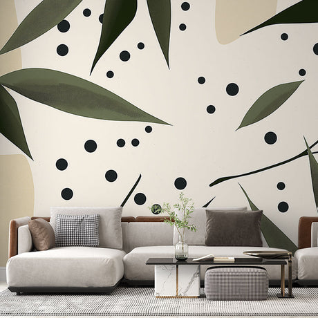 Modern botanical wallpaper with leaves and dots pattern shown in a bright living room with minimal furniture