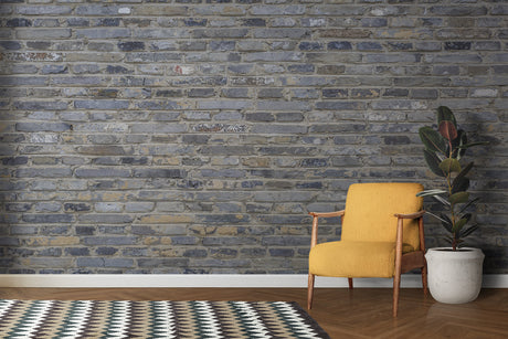 Industrial grey brick wallpaper in modern living room with leather sofa and metal accents