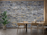 Blue-grey brick wallpaper creating accent wall in urban dining room
