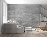 Industrial brick wallpaper creating accent wall in bedroom with metal bed frame