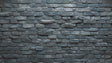 Grey brick mural wallpaper creating an industrial look in a modern living room with leather sofa