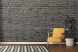 Grey brick wall mural in industrial kitchen with stainless steel appliances