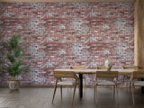 Red brick wallpaper mural creating an industrial accent wall in a modern living room with leather furniture