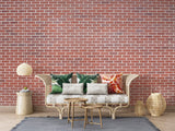 Red brick wallpaper bringing industrial charm to a modern living room with leather furniture