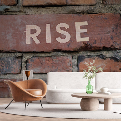 Industrial brick wallpaper with RISE typography shown in modern office space, creating an inspiring accent wall