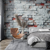 White brick wallpaper creating industrial charm in a modern living room with gray sofa and metal accents