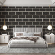 Modern black brick wallpaper creating a striking feature wall in a minimalist living room with grey sofa and metal accents