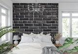 Modern black brick wallpaper in contemporary living room showing textured industrial design and natural lighting effects