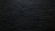 Black brick wallpaper in modern living room with leather sofa and metal lighting fixtures