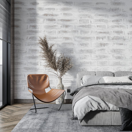 Modern grey brick wallpaper in a minimalist living room with leather sofa and industrial lighting