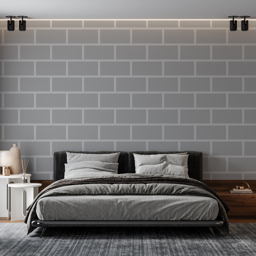 Modern grey brick wallpaper creating an industrial accent wall in a minimalist living room with black furniture