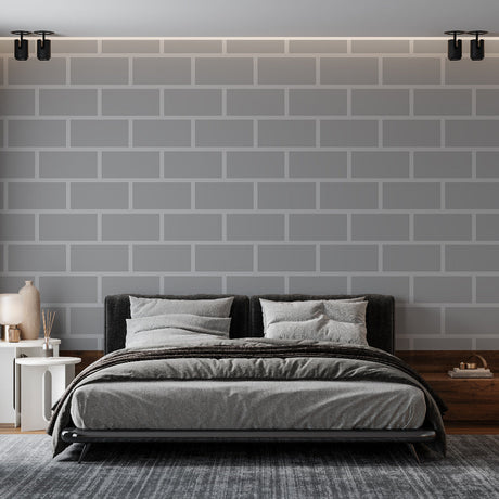 Modern grey brick wallpaper creating an industrial accent wall in a minimalist living room with black furniture