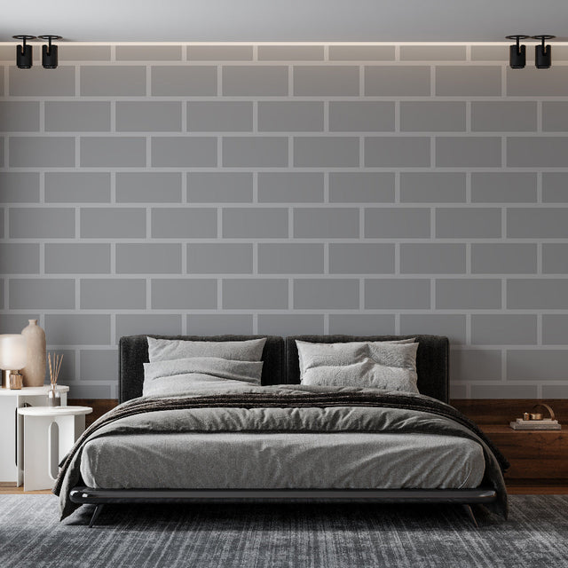 Modern grey brick wallpaper creating an industrial accent wall in a minimalist living room with black furniture