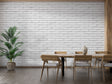 Modern white brick wallpaper in bright living room with grey sofa and natural light