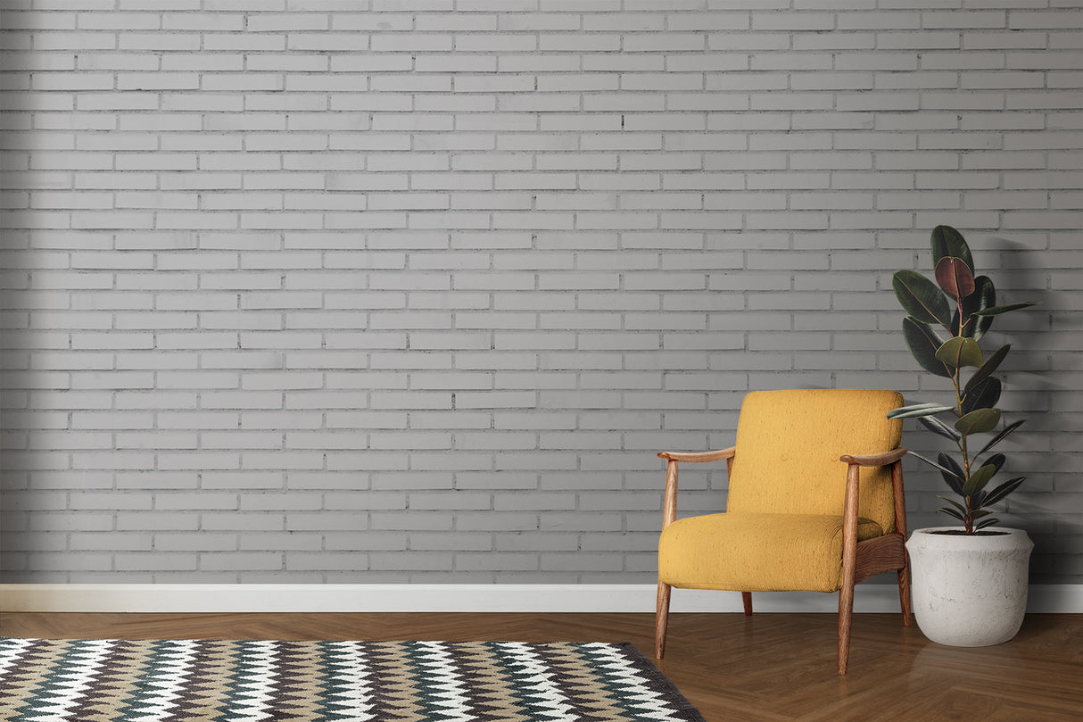 Grey brick wallpaper creating accent wall in minimal dining room setup