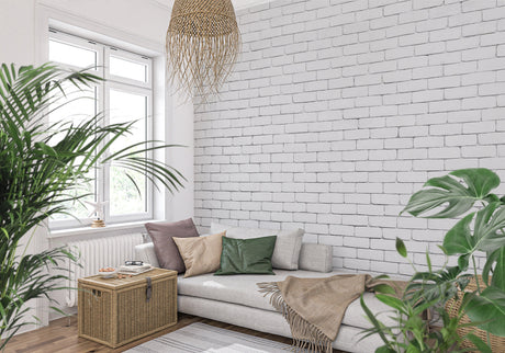 White brick mural wallpaper in modern living room with gray sofa and plants