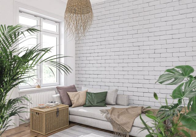 White brick mural wallpaper in modern living room with gray sofa and plants