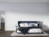 White brick mural wallpaper in modern living room showing clean industrial style and natural light