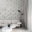 Modern white brick wallpaper creating a bright, airy atmosphere in a contemporary living room setting