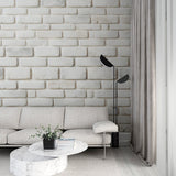 Modern white brick wallpaper creating a bright, airy atmosphere in a contemporary living room setting