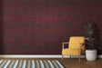 Red brick wallpaper creating industrial charm in modern living room with gray sofa and metal accents