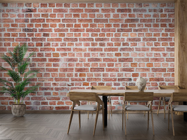 Vintage brick wallpaper creating an industrial feel in a modern living room with leather sofa