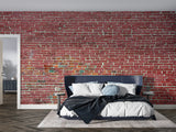 Red brick mural wallpaper in home office with metal desk and exposed beams