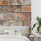 Vintage terracotta brick mural in industrial-style kitchen with metal fixtures