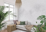White brick texture wallpaper in modern living room with grey sofa and natural light