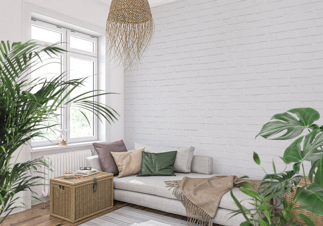 White brick wallpaper in modern living room with grey sofa and natural light