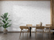 White brick wallpaper in modern living room with gray sofa and industrial lighting