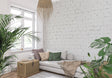 White brick wallpaper in modern living room with grey sofa and natural light