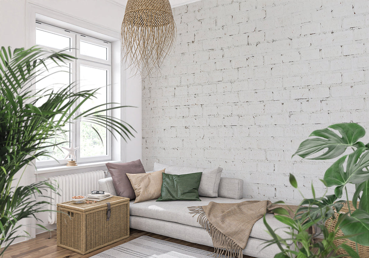 White brick wallpaper in modern living room with grey sofa and natural light