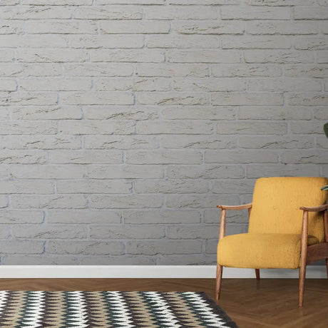 White brick wallpaper mural creating an industrial accent wall in a bright modern living room with minimalist furniture