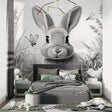 Black and white bunny wallpaper in modern nursery with white furniture