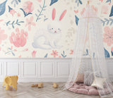 Bunny wallpaper in modern nursery with white furniture and pink accents