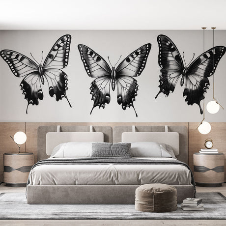 Black and white butterfly mural wallpaper creating drama in a modern living room with minimal furniture