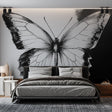 Black and white butterfly wall mural creating dramatic impact in a modern living room with minimalist furniture
