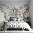 Black and white butterfly line art wallpaper creating an elegant statement wall in a modern living room setting