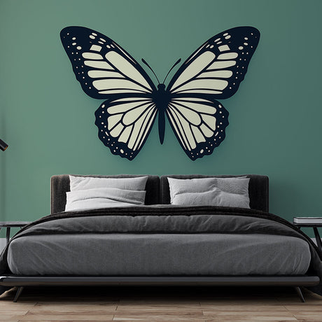 Black and white butterfly wall mural creating modern contrast in a bright living room with minimal furniture